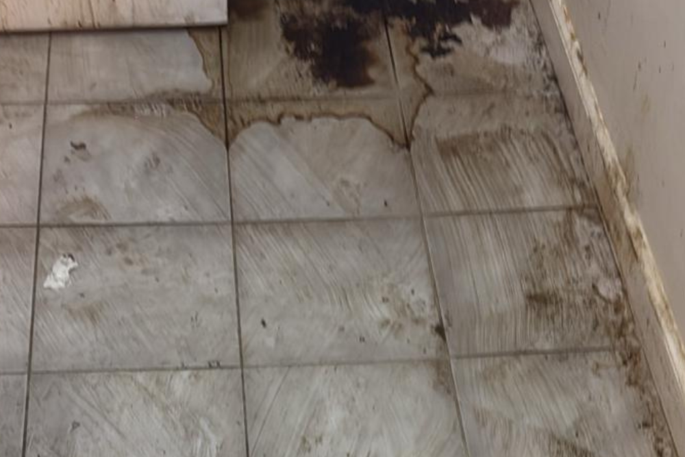 Greasy commercial floor with buildup and stains before professional cleaning