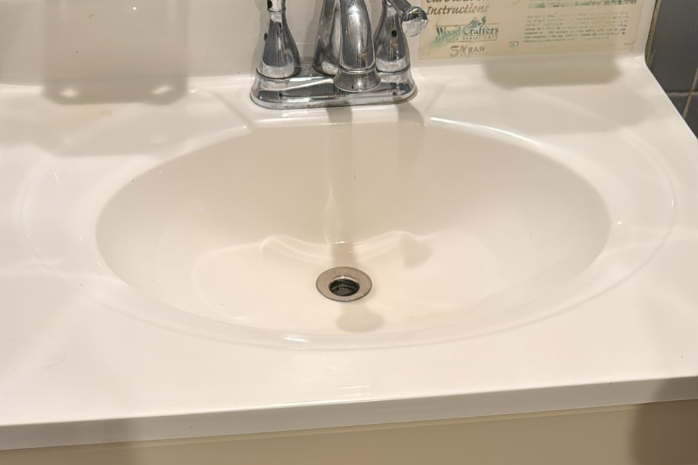 Shiny spotless sink with clean finish after professional bathroom deep cleaning and polishing