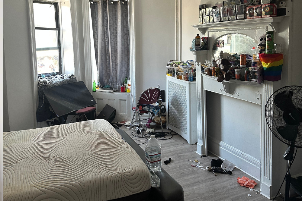 Hoarded cluttered bedroom filled with trash and items before professional anti-hoarding cleanup service