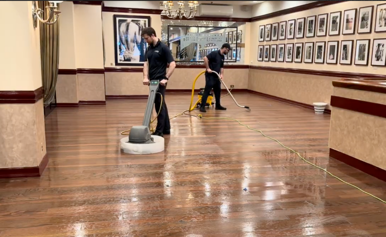 Professional cleaner using buffing machine to polish and restore shine to commercial floor
