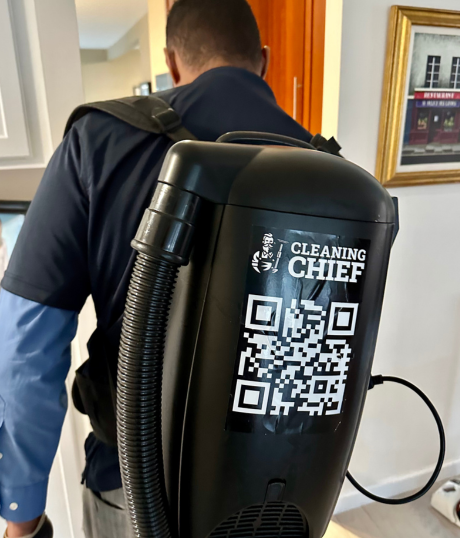 Professional cleaner using industrial construction vacuum for post-construction debris removal and cleanup