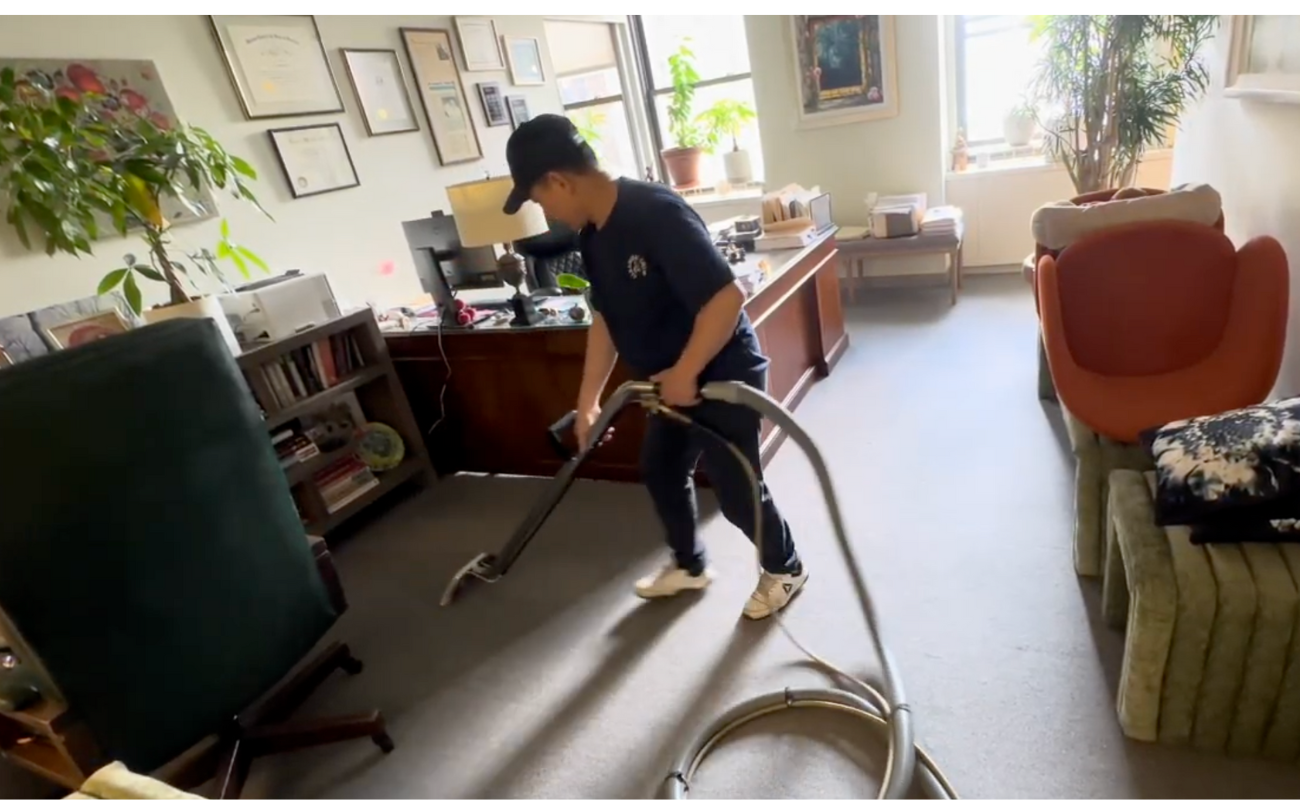 Professional cleaner steam cleaning and sanitizing surfaces in attorney's office
