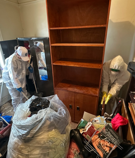Two professional cleaners performing super deep cleaning and decluttering for anti-hoarding service